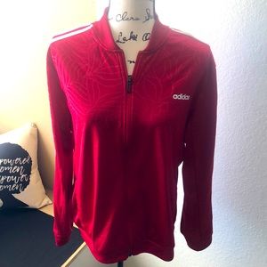 Adidas red jacket with a leaf design
